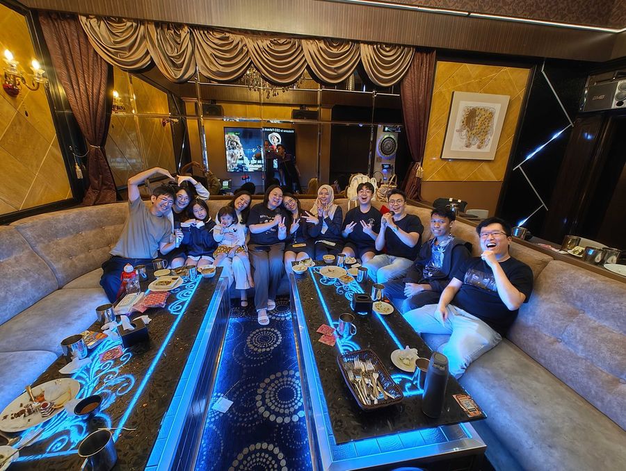 The team making hand hearts in a private karaoke room