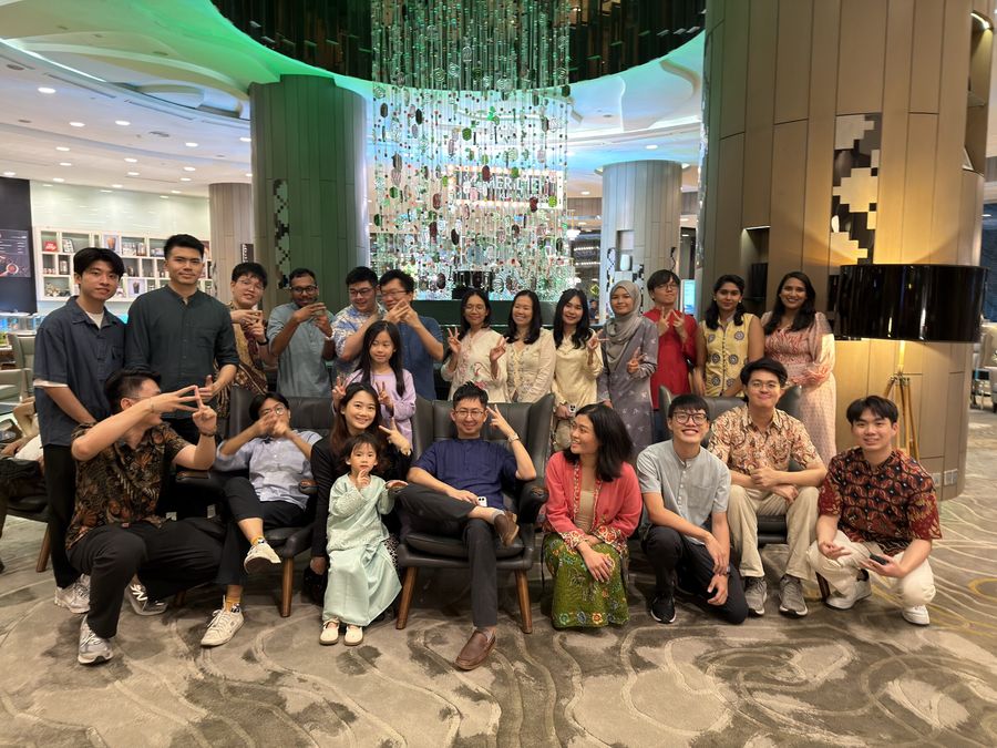 The Bukku team in festive outfits posing together in a hotel lobby after a Ramadan buffet